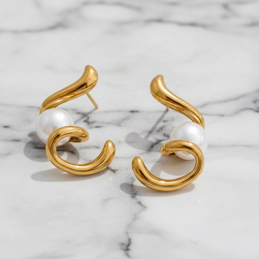 Gold and white earrings on a white background