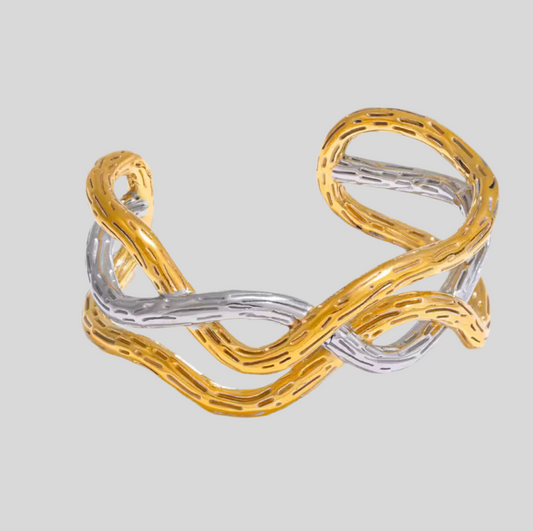 Gold and silver bracelet on a light gray background
