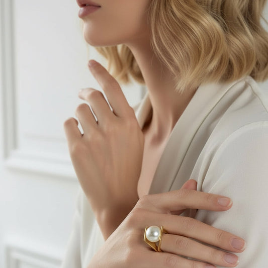 Woman wearing a pearl ring with a blurred background