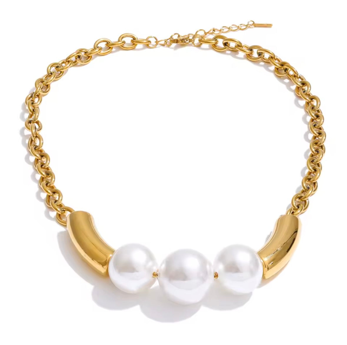 Gold necklace with three pearls on a white background