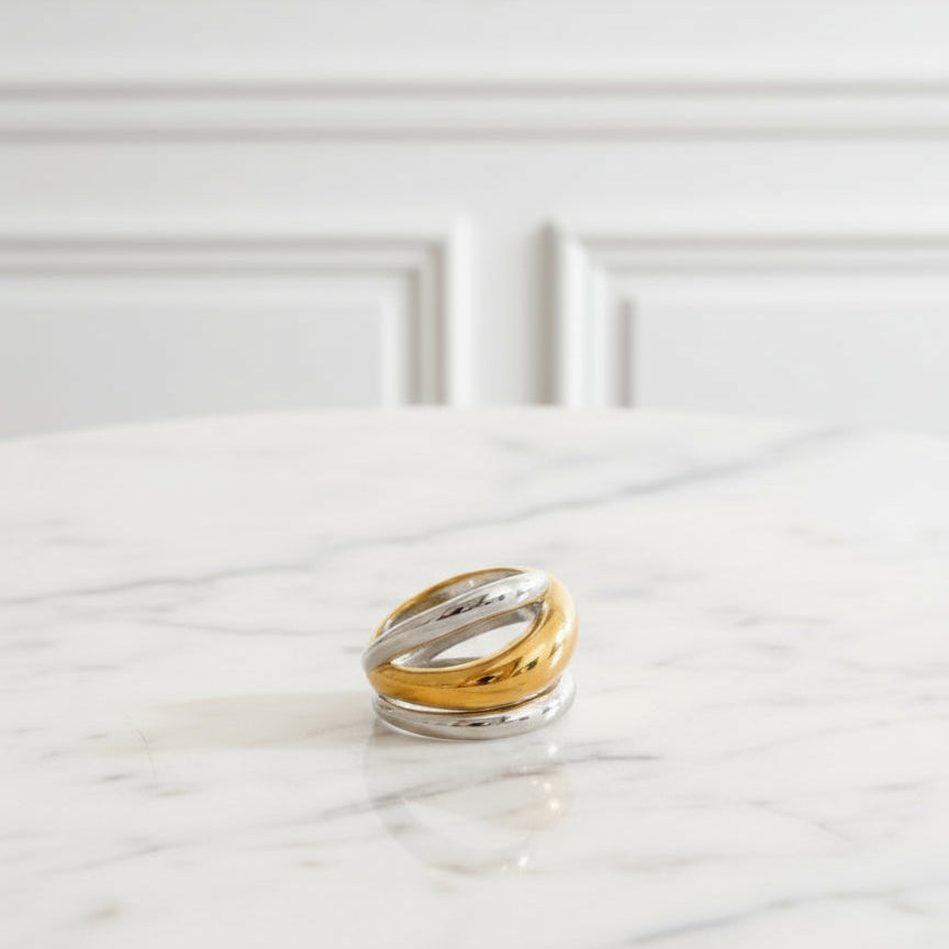 a gold and silver rings on a textured surface