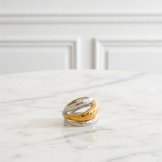 a gold and silver rings on a textured surface
