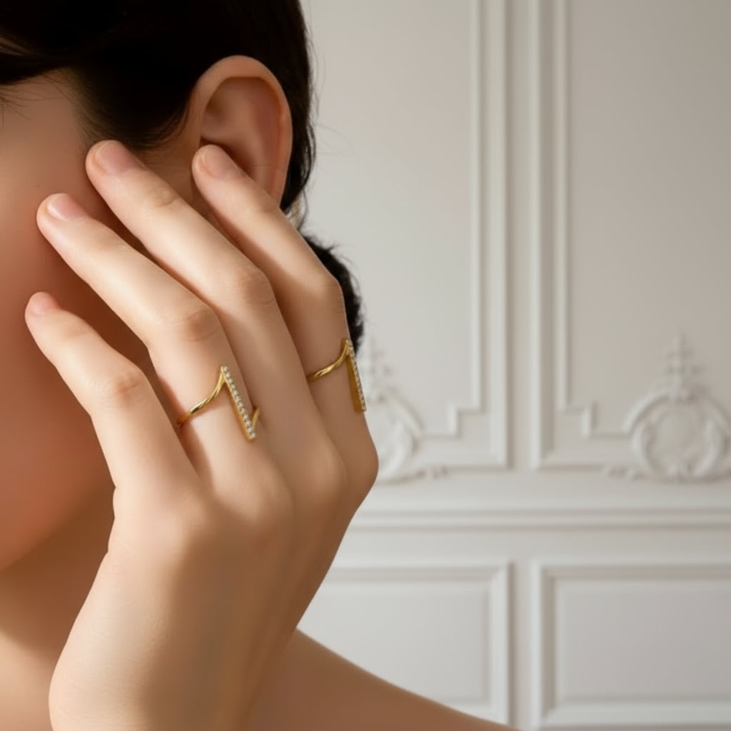 Close-up of a hand with a gold ring covering an ear